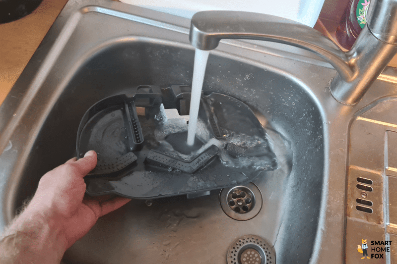 Cleaning the docking station tray of the Roborock Q Revo